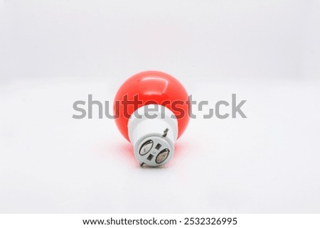 Base view of a zero watt bulb orange-red colored with white base