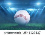 baseball ball lying on grass during tournament at stadium with floodlights. Baseball championship, creative idea