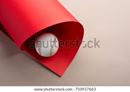 Baseball ball on grey and red background with copy space.
