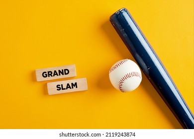 Baseball Ball And Wooden Bat On Yellow Background With The Words Grand Slam On Wooden Blocks. Home Run Hit In Baseball.