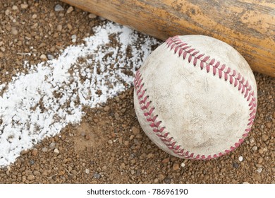 A baseball bat and ball in a baseball diamond