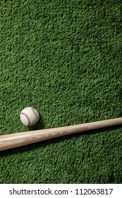 Baseball Bat And Ball On Green Turf Background