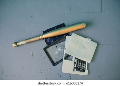 Baseball Bat And Broken Laptop