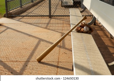 Baseball Bat and Glove on the bench of the dugout
