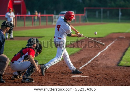 Baseball batter hits the ball