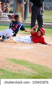 Baseball Boy Sliding In At Home Plate During Game.