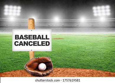 Baseball Canceled Sign On Baseball Bat Stuck To The Ground With Glove And Ball In Empty Stadium. Concept Of Baseball Season Canceled Due To Covid-19, Breakdown In Talks With Players Union Or Disasters