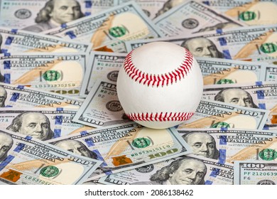 Baseball with cash money. Major league strike, lockout and sports betting concept. - Shutterstock ID 2086138462
