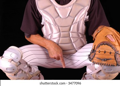 Baseball Catcher In Gear Giving Sign To Pitcher, With Black Background