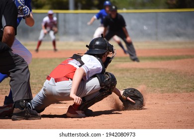 Baseball Catcher Stopping A Ball In The Dirt With The Back Hand Catcher Glove