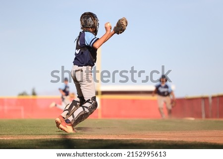 baseball catcher throwing ball to first baseman