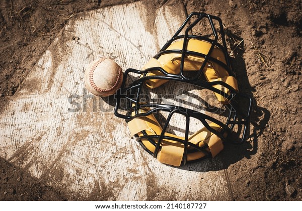 Baseball catcher\'s mask on\
home plate