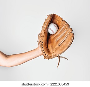 Baseball is caught in worn baseball glove.