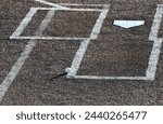 Baseball and chalk by home plate on a baseball field