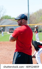 Baseball Coach At First Base Line Looking At Batter.