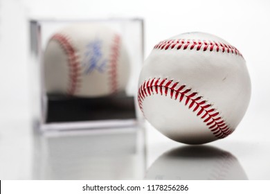 Baseball With Display Case Autographed Memorabilia Blurred In Background Isolated On White