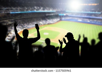 Baseball fans and crowd cheering in stadium and watching the game in ballpark. Happy people enjoying a match and sport event in arena. Friends watching ballgame live.