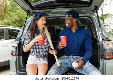 Baseball Fans Sitting In Car Boot At A Tailgate Party