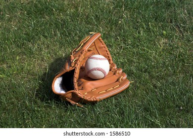 Baseball And Glove Against A Grass Background