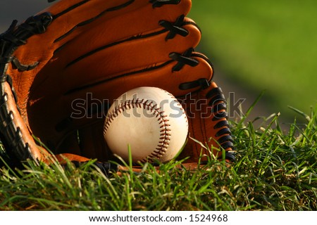 Baseball and glove on the grass after the big game