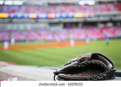 Baseball glove on the wall with a major league stadium in the background