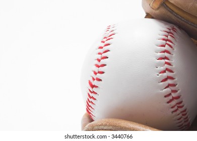 A baseball inside of a baseball glove.