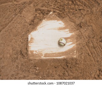 Baseball Laying With Homeplate On Dirt Field For Game.  