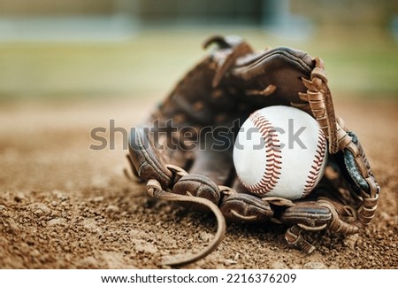 Baseball, leather glove and ball on pitch sand after fitness, workout or training for match or competition. Zoom, texture and softball mitt on field for sports team, wellness exercise or stadium game