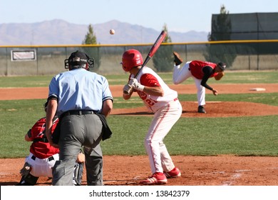 Baseball In Mid-air Pitched To Batter With Back-side View Of Batter, Catcher And Umpire At Cochise College Baseball Game