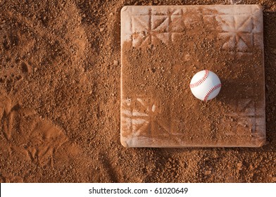 Baseball On A Base Covered With Dirt From A Slide