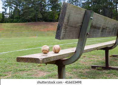 Baseball On A Bench In A Little League Field