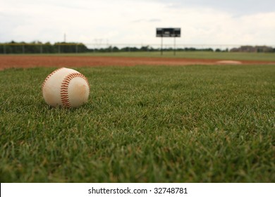 Baseball on the field with first base in the background
