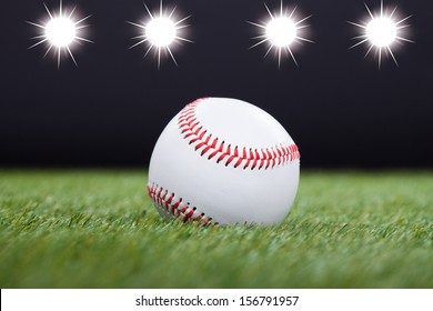 Baseball On Grass Field With Light In The Background