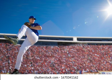 Baseball pitcher in crowded stadium throwing ball during game