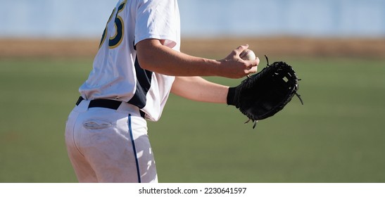 Baseball pitcher ready to pitch in baseball game, college softball player - Powered by Shutterstock