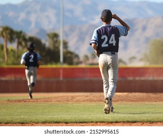 baseball pitcher running to the mound to warm up for the inning - Powered by Shutterstock