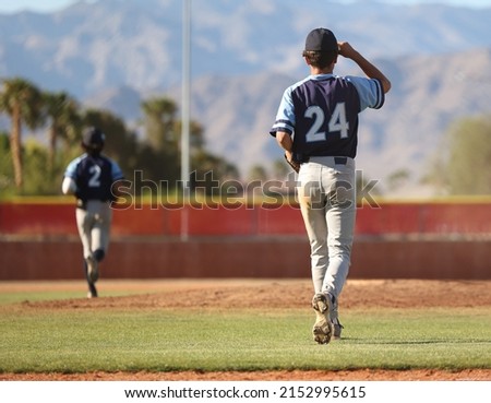 baseball pitcher running to the mound to warm up for the inning
