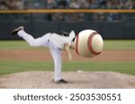 Baseball pitcher throwing fast ball to batter in a stadium