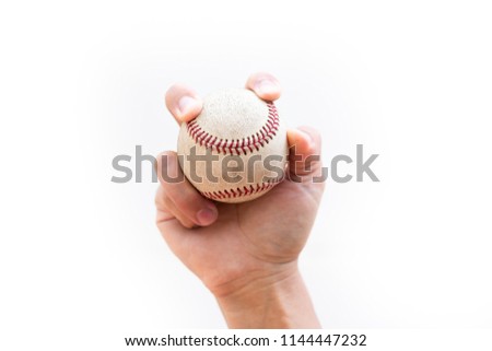 Baseball play : Two seam fastball grip - Fingers rest along and with the seams with open space between the base of the fingers and the palm of the hand.
close up on a white background with copy space.