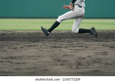 Baseball Player Attempting To Steal A Base During A Baseball Game.