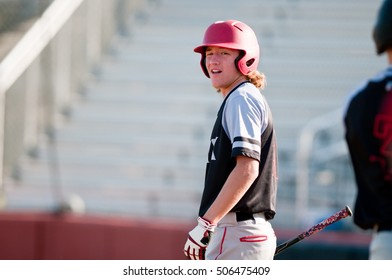 Baseball Player In Black And Grey Jersey Looking Back While Batting.