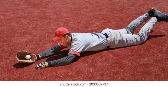 Baseball Player Diving to Catch the Ball