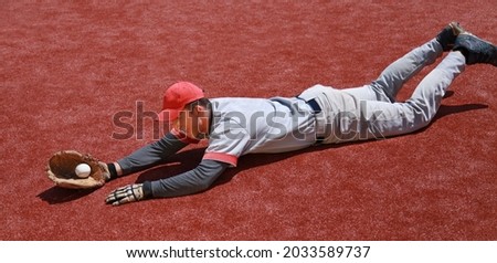Baseball Player Diving to Catch the Ball