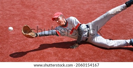 Baseball Player Diving to Catch the Ball