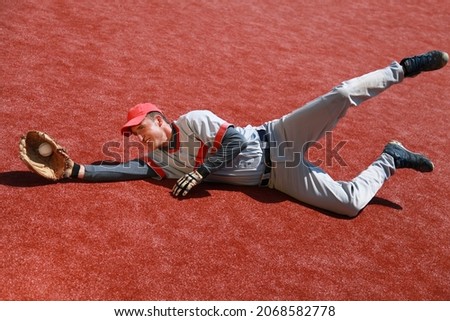 Baseball Player Diving to Catch the Ball