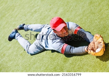 Baseball Player Diving to Catch the Ball