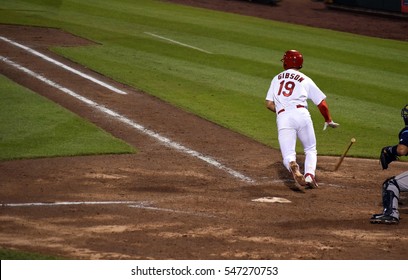 Baseball Player Dropping The Bat After Hitting The Ball And Running To First Base.