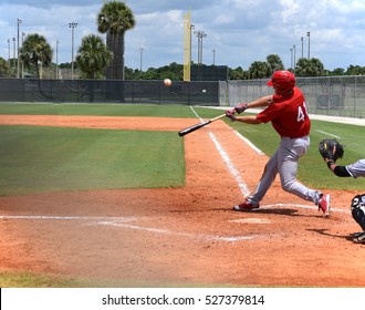 Baseball Player In Full Stride Just Before He Hits The Ball For A Home Run.