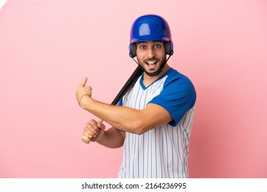 Baseball Player With Helmet And Bat Isolated On Pink Background Pointing Back