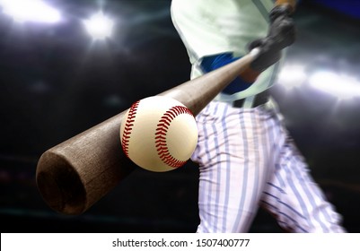 Baseball Player Hitting Ball With Bat In Close Up Under Stadium Spotlights